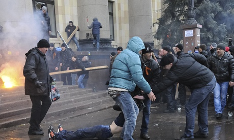 Pro-Russian protesters drag a wounded comrade away in Kharkiv following clashes with supporters of Ukraines new government on 1 March. 