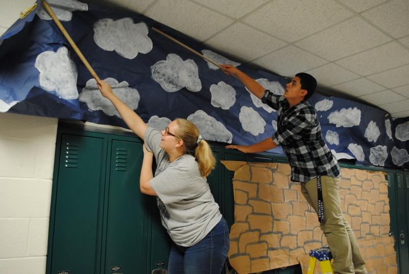 Freshman Emma Duelm helps her class decorate the hallway according to their theme, Beijing, China.  Each class worked quickly to get the hallways done in time for judging on Wednesday afternoon.  