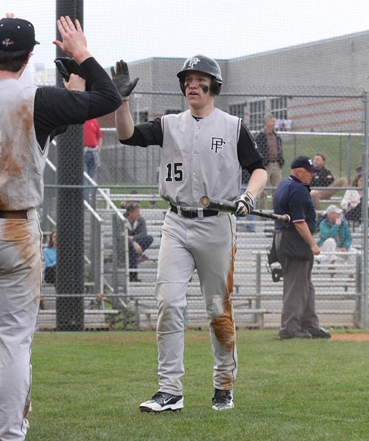 Being congratulated by a teammate, senior Michael Smith runs off the field. At a rival game against Dominion, Smith celebrated a run batted in. Photo submitted by Susan Smith. 
