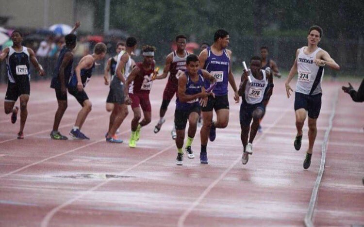 Running as fast as they can, the boys varsity track and field team passes the baton. The team put all of their effort into winning. Photo submitted by: Jad Raqi