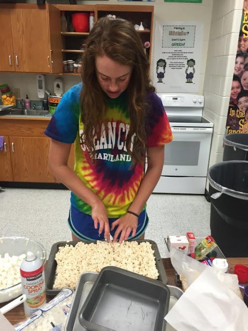 Caitlin Schlosberg making rice krispie treats for the home tailgate.  The tailgate kept help a large crowd for the Falls Church win.