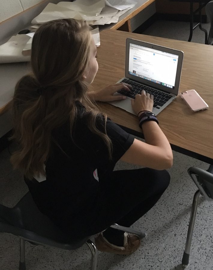 Senior Madison Patrick typing up notes on her laptop. Photo taken by Olivia Miller. 