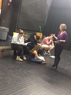 Ms. Deker instructs (from L to R) Caroline Dunn, Sophie Pauly, Elias Tafwed, and Gabriel Moura on how to deliver their lines.