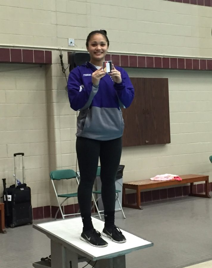 Fie’eiki stands on the platform holding her state medal from last year’s competition. She was to repeat her dominating performance this year.
Photo courtesy of Charlotte Fie’eiki