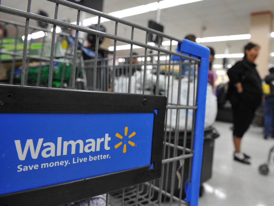 Shoppers wait in line to pay for their purchases at a Walmart store in Los Angeles, California on November 24, 2009, a few days before Black Friday the day after Thanksgiving which kicks off the holiday shopping season. Retailers are hoping doorbuster deals will stimulate sales despite the weak economy.   AFP PHOTO / Robyn Beck (Photo credit should read ROBYN BECK/AFP/Getty Images)