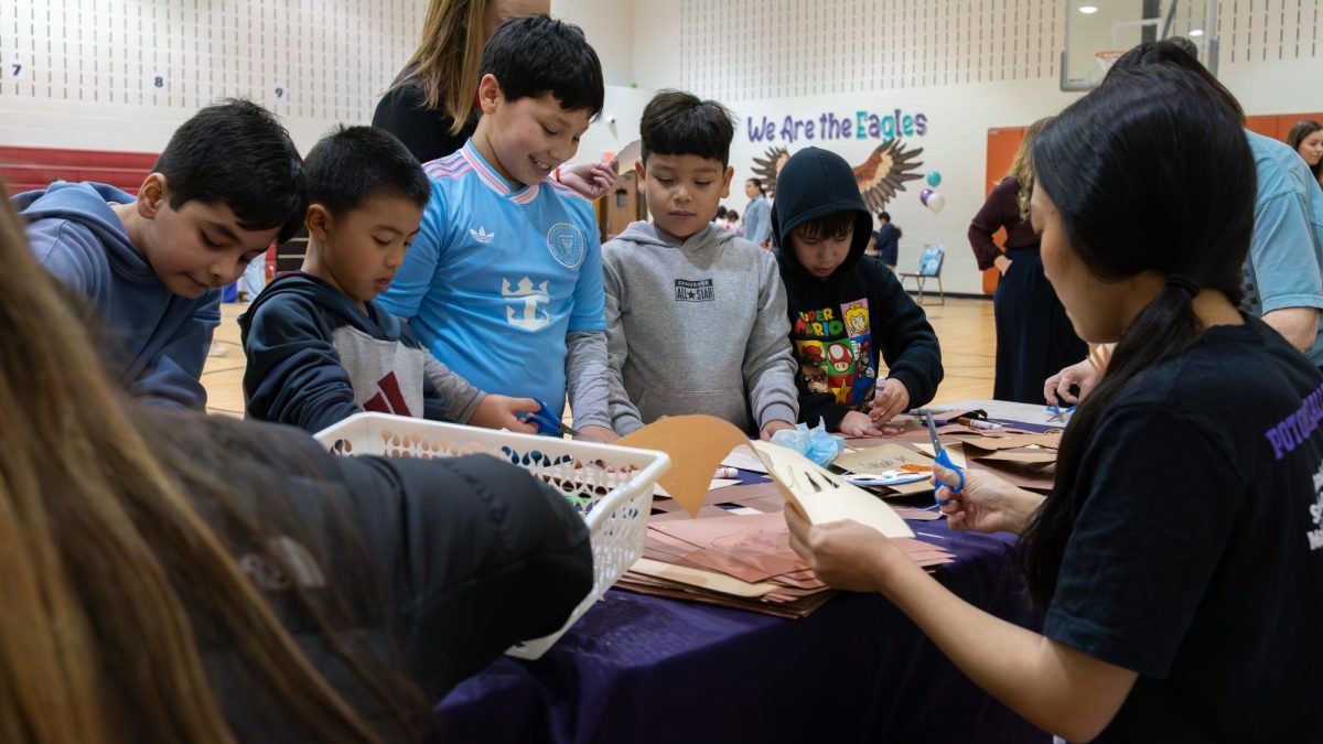 Senior Cadyn Sohn running a table at the  Kindness Fair at Powtowmack Elementary School